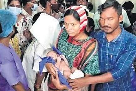 Pavani holds her baby boy at the Mancherial hospital on Tuesday