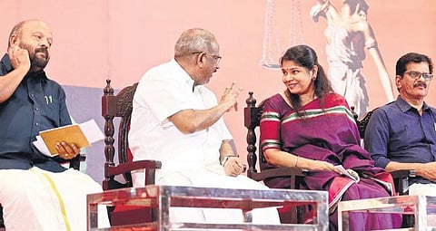 CN Mohanan shares a light moment with Kanimozhi during the seminar organised by All India Lawyers Union in Kochi on Tuesday. Former minister VS Sunilkumar is also seen | TP Sooraj
