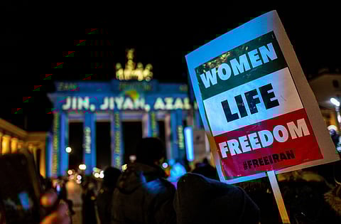 An activist displays a placard inscribed with the words 'Women, Life, Freedom', during a demonstration in Berlin, in support of Iran's demonstrators, December 13. (Photo | AFP)