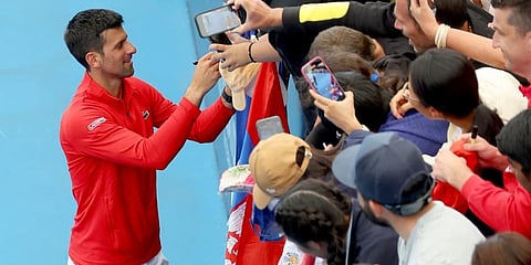 Serbia's Novak Djokovic signs autographs after defeating France's Quentin Halys during their Round of 16 match at the Adelaide International Tennis tournament. (Photo | AP)