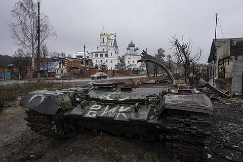 A destroyed Russian tank stands across the road of a church in the town of Sviatohirsk, Ukraine. (Photo | AP)