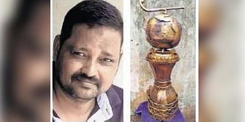 Artist Sanjib Biswal and a replica of the hockey World Cup trophy | Express