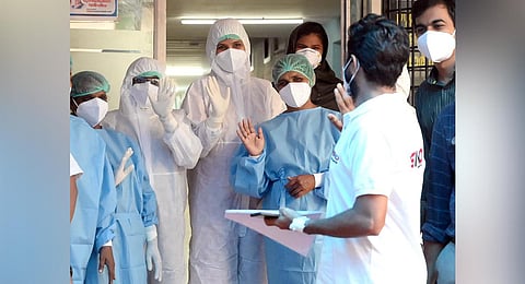 A Nipah survivor from Feroke exchanges pleasantries with health workers who treated him at Kozhikode Medical College Hospital. (Photo | E Gokul)