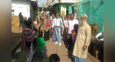 Shachindra Pratap Singh, distributing brooms through his ‘Jhaadu Daan’ group.