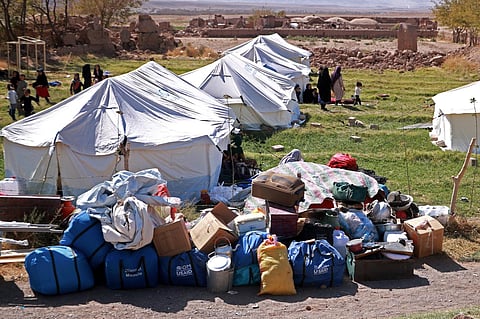 Afghan residents walk past their makeshift shelters set-up after earthquake in Wardakha village, Zendeh Jan district of Herat province on October 10, 2023. (Photo | AFP)