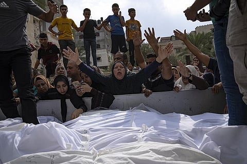 Relatives mourn people killed in an Israeli air strike in Gaza City on Monday, Oct. 9, 2023. (Photo | AP)