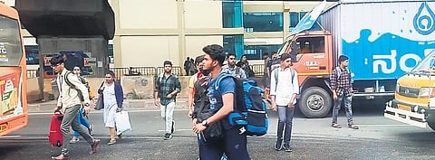 Students dart across the busy highway in a hurry to reach their colleges | Express