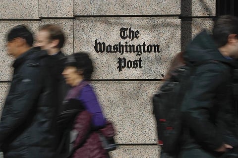 FILE - People walk by the One Franklin Square Building, home of The Washington Post newspaper, in downtown Washington on Feb. 21, 2019. (Photo | AP)