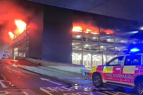 A parking structure is on fire at London's Luton Airport. (AFP)