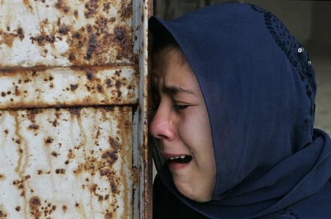 FILE - A Palestinian woman who had ten relatives killed near a United Nations school, weeps during their funeral in the Jebaliya refugee camp in the Gaza Strip in 2009. (Photo | AP)