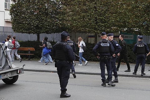 Schoolchildren leave the area after a man armed with a knife killed a teacher and wounded two others at a high school in northern France, Friday, Oct. 13, 2023 in Arras. (Photo | AP)