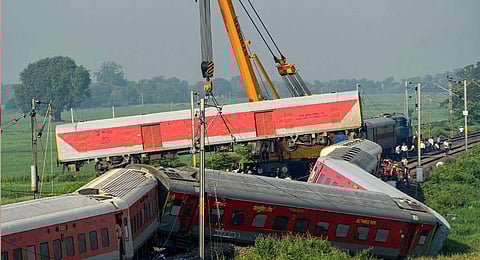 A crane removes a derailed coach of North East Express from the track a day after its derailment near Raghunathpur railway station in Buxar district, Thursday, Oct. 12, 2023. (PTI)
