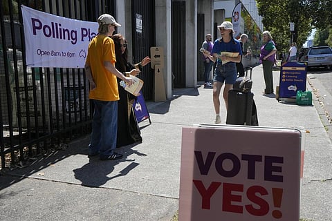 Volunteers talk with people coming to vote at a polling place in Redfern as Australians cast their final votes in Sydney, Oct 14, 2023. (Photo | AP)