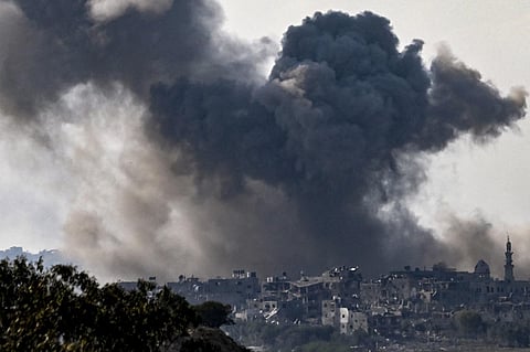 A picture taken from Sderot shows smoke plumes rising above buildings during an Israeli strike on the northern Gaza Strip on October 14, 2023. (Photo | AFP)