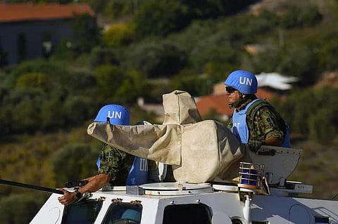 UN peacekeepers patrol on the Lebanese side of the Lebanese-Israeli border in the southern village of Kfar Kila, with the Israeli town of Metula in the background, Lebanon, Oct. 13, 2023. (Photo | AP)