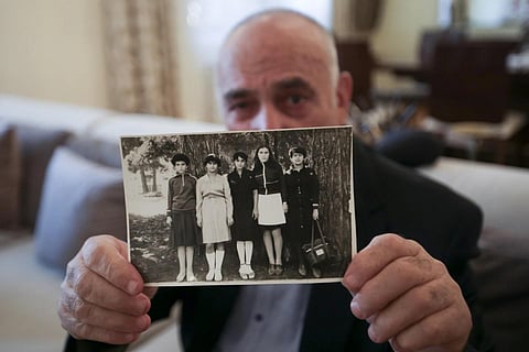 Mubariz Aliguleyev, father of Bahar Aliguleyeva, shows a photo of his daughter taken in Khankendi in 1986 in Baku, Saturday, Oct 7, 2023. (Photo | AP)