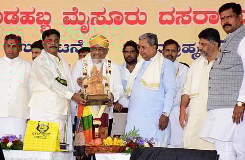 Chief Minister Siddaramaiah felicitates music director Hamsalekha, who inaugurated the Dasara festivities in Mysuru. (Photo | Udayashankar S)