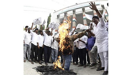 Supporters of dejected Congress aspirants burn the effigy of Telangana Congress chief Revanth Reddy at Gandhi Bhavan in Hyderabad (Photo | EPS)