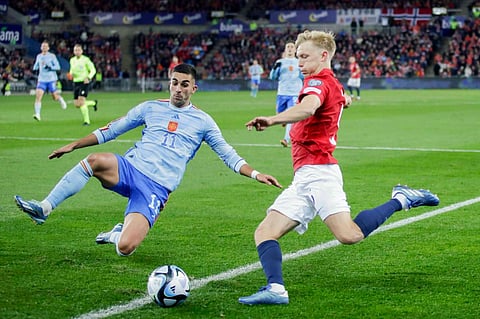 Spain's Ferran Torres and Norway's Birger Meling fight for the ball. (Photo | AP)