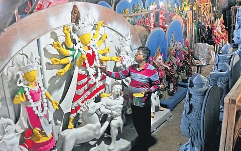 An artist gives the finishing touches to an idol of Goddess Durga ahead of the festivities |  Vinod Kumar T