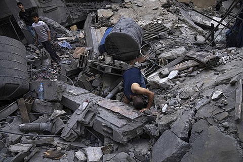 Palestinians look for survivors in a building destroyed in Israeli bombardment in Rafah refugee camp in Gaza Strip on Tuesday, Oct. 17, 2023. (Photo | AP)