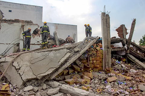 Police personnel and firefighters at the site after an explosion at a soap-making factory, at Lohia Nagar in Meerut, Tuesday, Oct. 17, 2023. (AP)