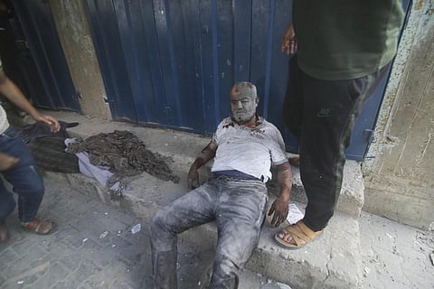 A Palestinian lies wounded after surviving Israeli bombardment of Rafah,  souther Gaza strip, Tuesday, Oct 17, 2023. (Photo | AP)