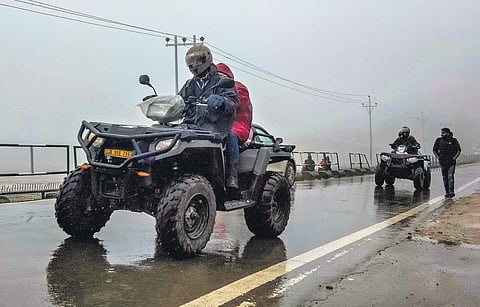 Tourists ride all-terrain vehicles after snowfall in Gulmarg on Tuesday | pti