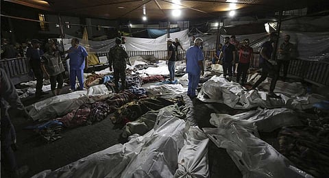 Bodies of Palestinians killed by an explosion at the Ahli Arab hospital are gathered in the front yard of the al-Shifa hospital, in Gaza City, central Gaza Strip, Tuesday, Oct. 17, 2023. (AP)