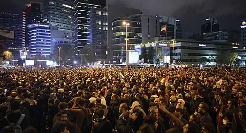 People gather outside the Israeli consulate during a protest to show solidarity with Palestinians, in Istanbul, Turkey, Tuesday, Oct. 17, 2023. (AP)
