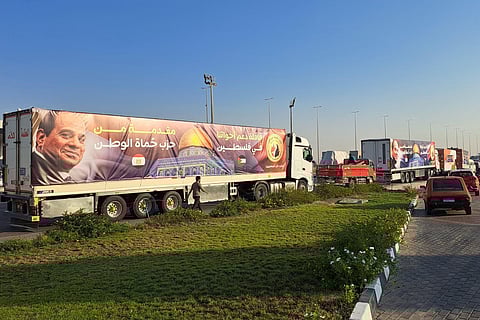 A convoy of trucks carrying aid supplies for Gaza from Egypt waits on on the main Ismailia desert road, about 300 kms east of the Egyptian border with the Gaza Strip. (Photo | AFP)
