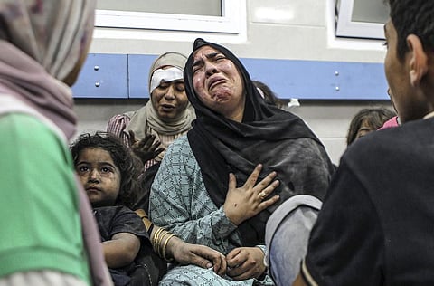 Wounded Palestinians wait for treatment in al-Shifa hospital in Gaza City