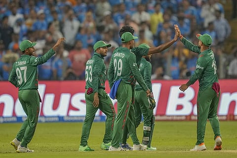 Bangladesh players celebrate the dismissal of India's captain Rohit Sharma during the World Cup match against India in Pune (Photo | AP)