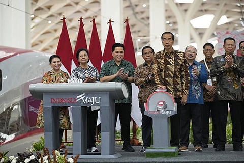 Indonesian President Joko Widodo press a bell during the opening ceremony for launching Southeast Asia's first high-speed railway at Halim station in Jakarta, Indonesia, Monday, Oct. 2, 2023. (Photo |