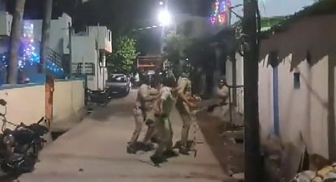 Police officials seen at the site of a stone-pelting incident during an Eid Milad procession in Shivamogga city, Karnataka (PTI Video grab)