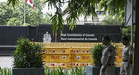 Security personnel stand guard in front of the High Commission of Canada in New Delhi. (Photo | AFP)