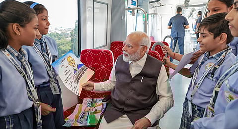 Prime Minister Narendra Modi interacts with school children at the Regional Rapid Train Namo Bharat, in Ghaziabad on Friday.(Photo | ANI)