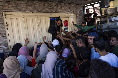 Palestinians crowding to buy bread from a bakery, in Khan Younis, Gaza Strip, on Oct, 15, 2023. (AP