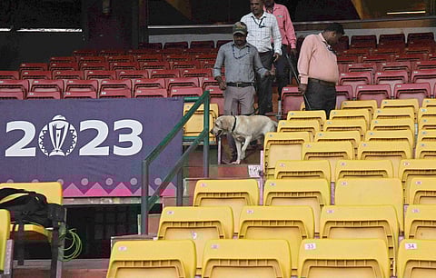 A sniffer dog inspects Chinnaswamy Stadium grounds during a security check ahead of ICC Cricket World Cup match at, in Bengaluru. (Photo | Vinod Kumar T)