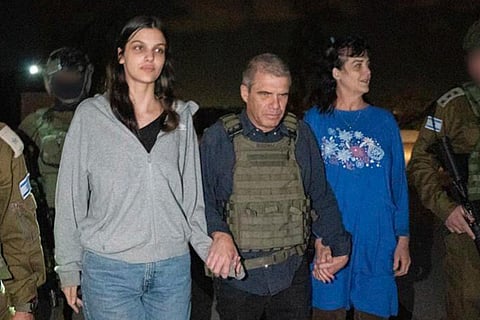 Hostages Judith Raanan, right, and her 17-year-old daughter Natalie are escorted by Israeli soldiers and Gal Hirsch, special coordinator for returning the hostages. (Photo | AP)