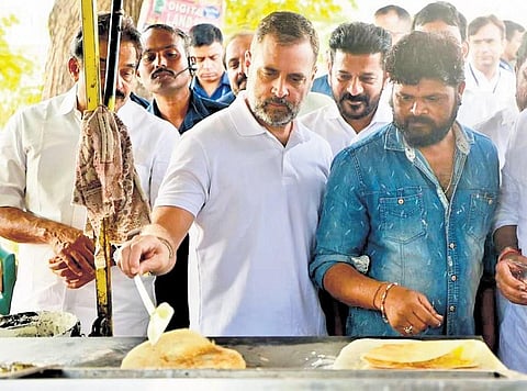 Rahul Gandhi tries his hand at preparing a dosa at roadside eatery at Nookapalli in Jagtial district on Friday