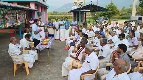 : S Prakadeesh Kumar speaks with farmers about the daily vegetable market in Poolambadi in Perambalur district. (Photo | Express)