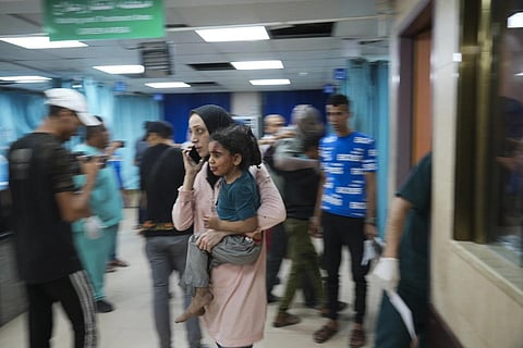 A Palestinian women brings her daughter wounded in Israeli bombardment to a hospital in Deir al-Balah, Oct 21, 2023. (Photo | AP)