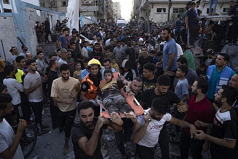 Palestinians carry an injured person on a stretcher after an airstrike in Khan Younis, Gaza Strip, Saturday, Oct. 21, 2023. (AP)