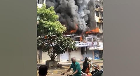 Smoke billows out after a fire broke out at the Pavan Dham Veena Santur Building in Mahaveer Nagar in the Kandivali West area of Mumbai on Monday, October 23, 2023. (Photo | PTI)