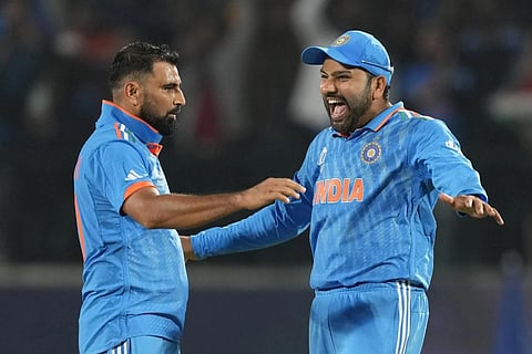 India's Mohammed Shami celebrates with captain Rohit Sharma after the dismissal of New Zealand's Matt Henry during the ICC Men's Cricket World Cup in Dharamshala, Oct 22, 2023. (Photo | AP)