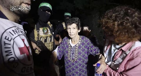 This image taken from video released by Al Qassam brigades, shows Yocheved Lifshitz, 85, shaking hands a thanking a member of Hamas as she is released to the Red Cross. (Photo | AP)