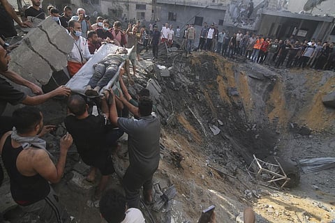Palestinians pull a boy from the rubble after an Israeli strike on the Zaroub family house in Rafah, Gaza Strip, Tuesday, Oct.24, 2023. (Photo | AP)