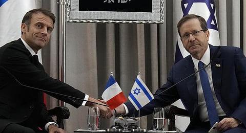 French President Emmanuel Macron, left, shakes hands with Israel's President Isaac Herzog in Jerusalem, Tuesday, Oct. 24, 2023.(Photo | AP)