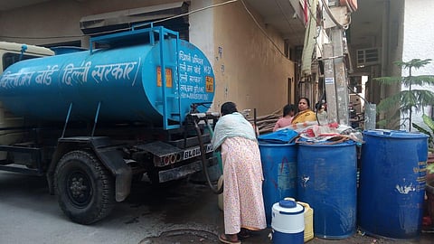 Residents wait for their turn near a water tanker at Nanda block | EXPRESS